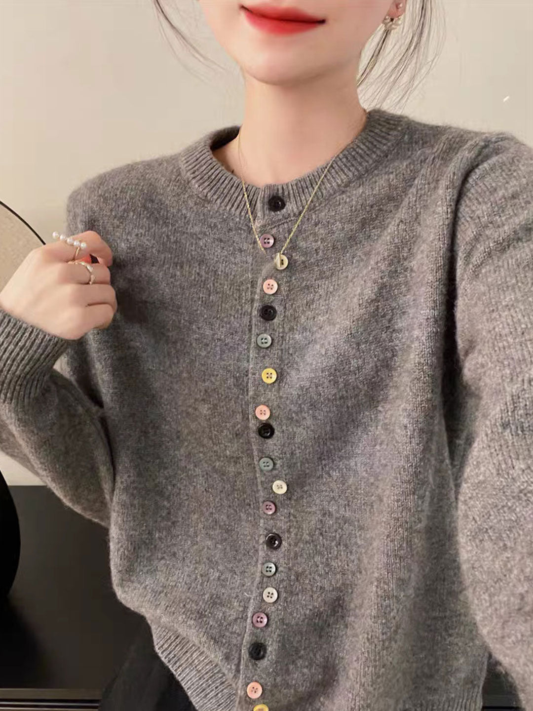 Gray knit cardigan with multicolor button placket and ribbed cuffs