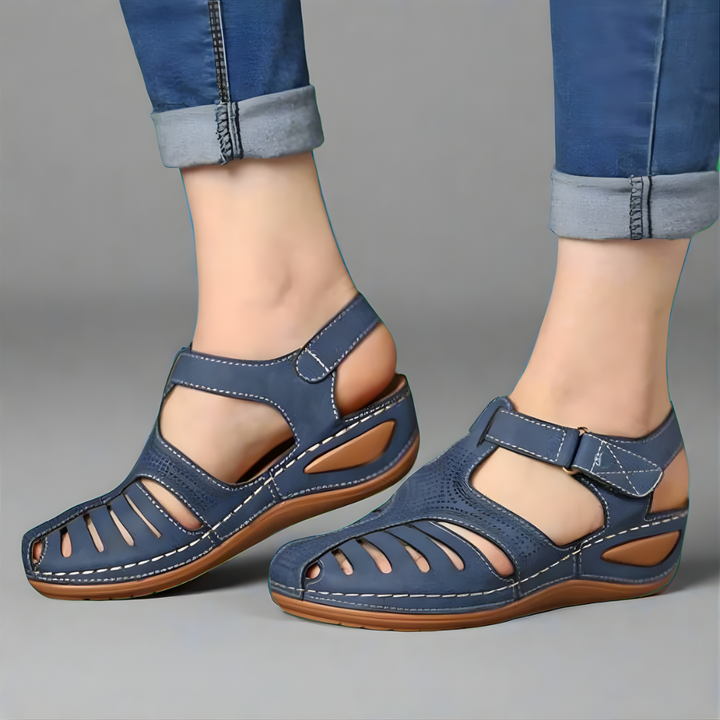Orthopedic bunion corrector sandal, blue leather-look with hook-and-loop strap.