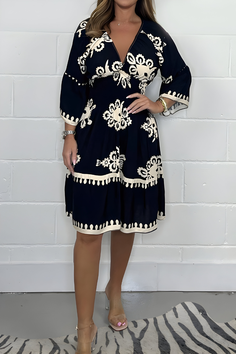 Navy knee-length dress with white embroidered florals and tassel-trim hem