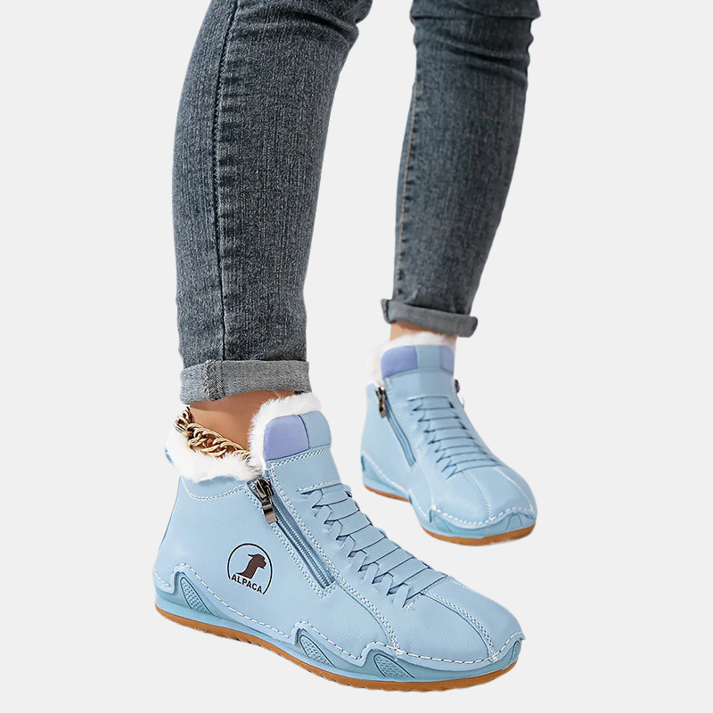 Light blue ankle boots with faux fur cuff, side zipper, lace-up front, and tan sole.