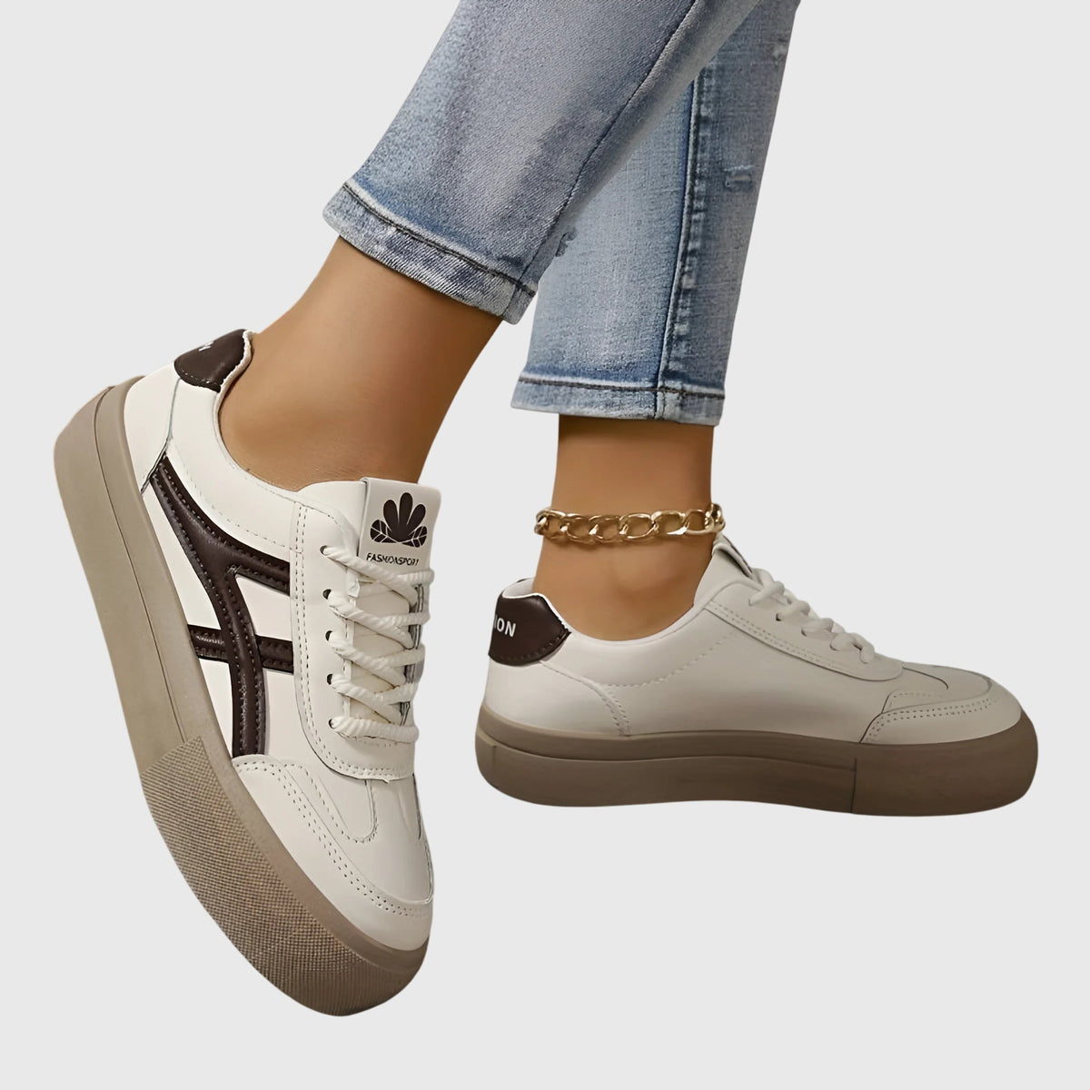 White orthopedic sneakers with dark brown side stripes and tan platform sole