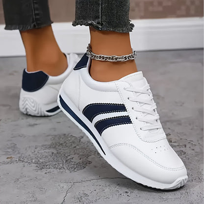 White orthopedic sneakers with navy heel tab and side stripes, lace-up