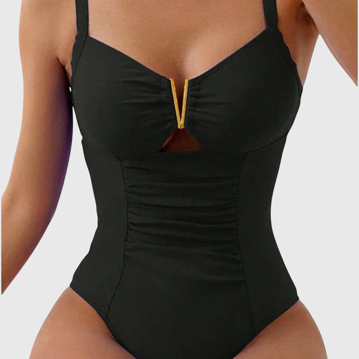 Women’s V-neck swimsuit in black with ruched front and gold center trim