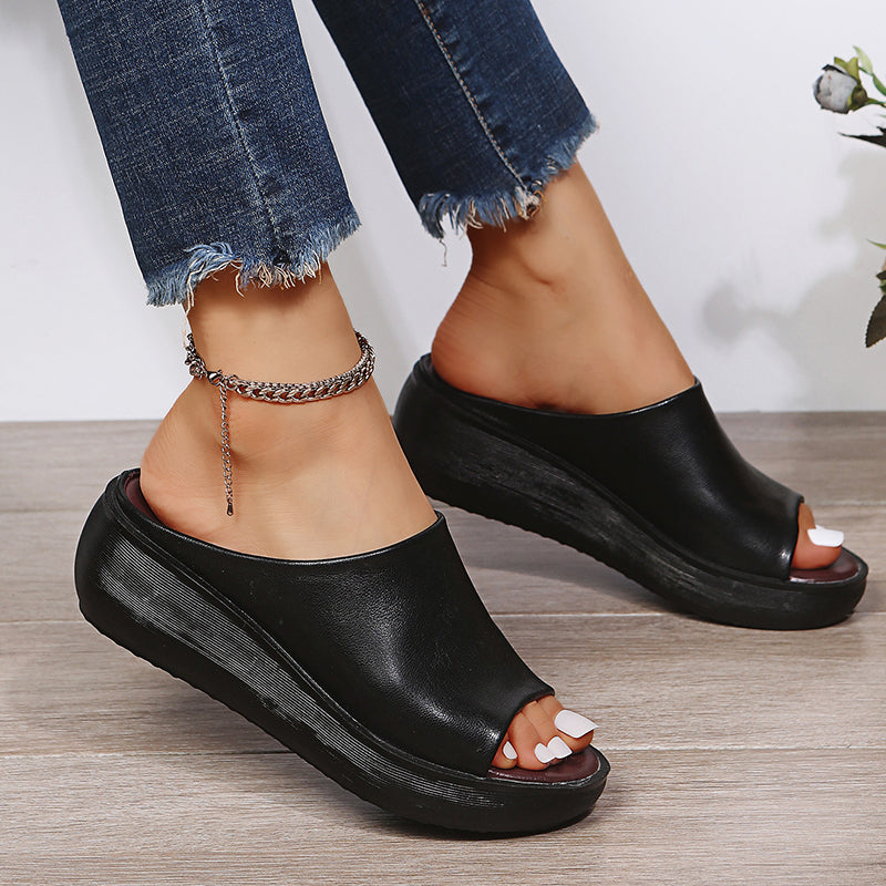 Black orthopedic slide sandals with wide open toe and thick platform sole
