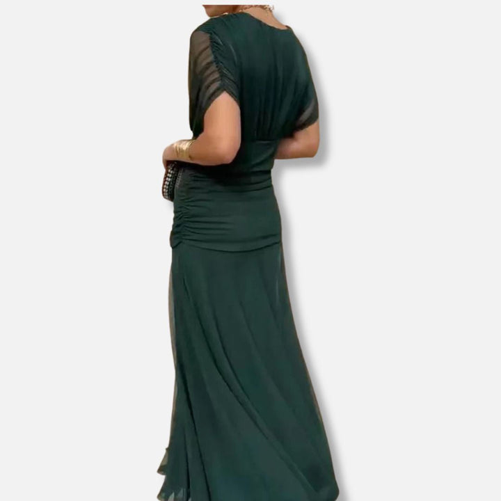 Elegant dress in deep green with cap sleeves and flowing skirt with side drape
