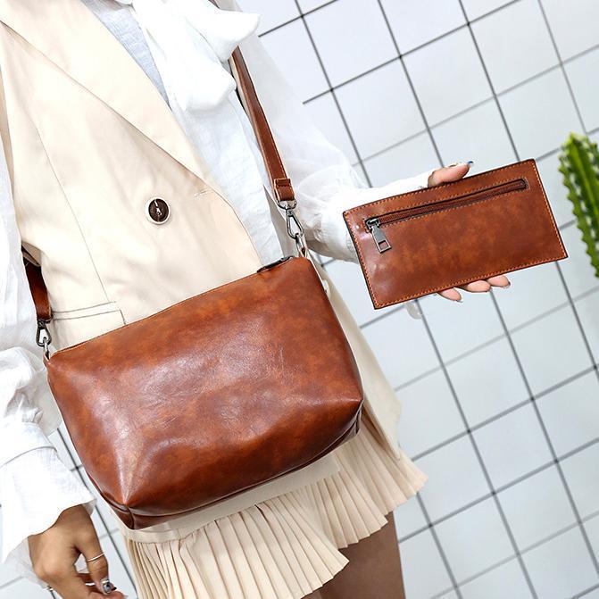 Brown shoulder tote with matching card wallet held in hand; women’s retro 4-piece set.