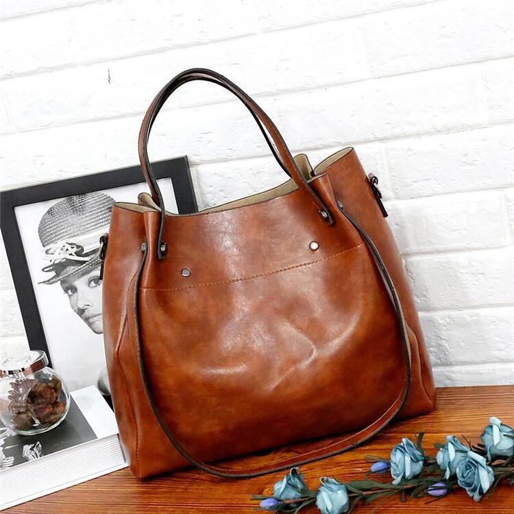 Brown leather-look tote bag with top handles and side snap pockets