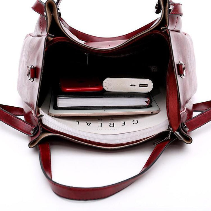 Red crossbody bag open with interior zip pocket and card slots