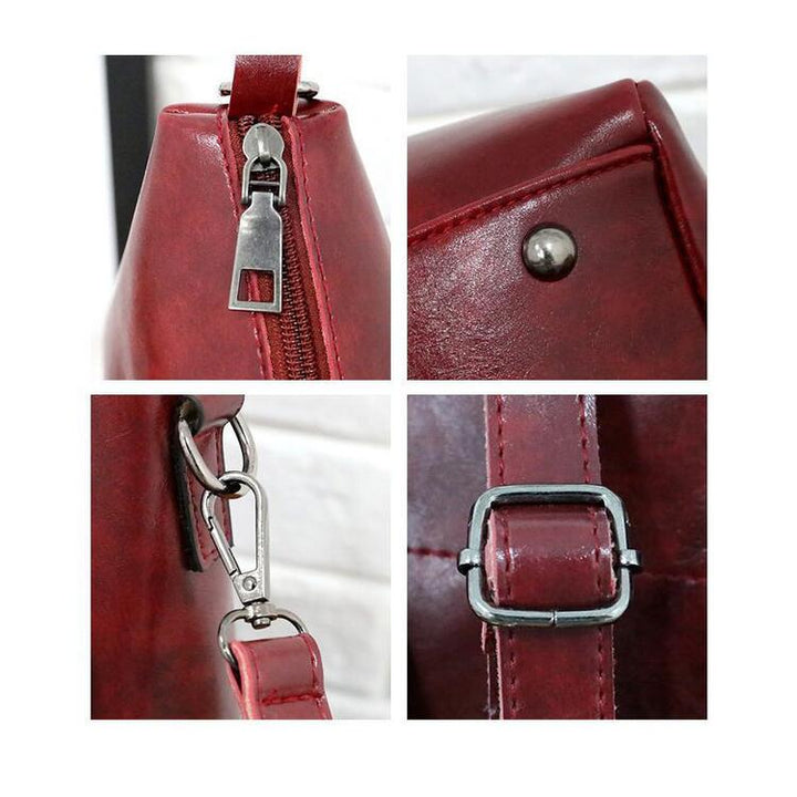 Red tote bag hardware close-up with zipper pull, snaps, and metal rings