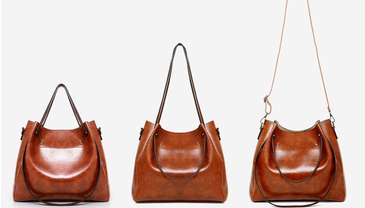 Set of three brown hobo handbags with curved fronts and top handles