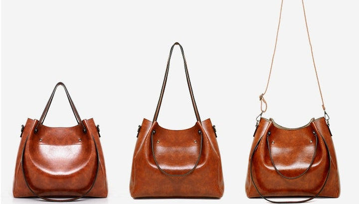 Set of three brown hobo handbags with curved fronts and top handles