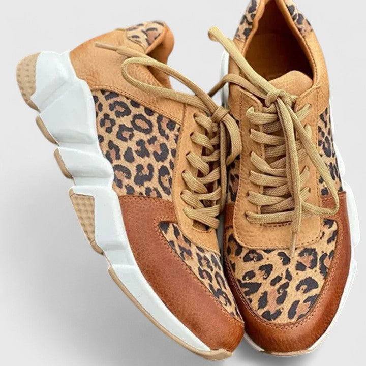 Leopard-print low-top sneakers with tan laces, cushioned white sole, brown trim