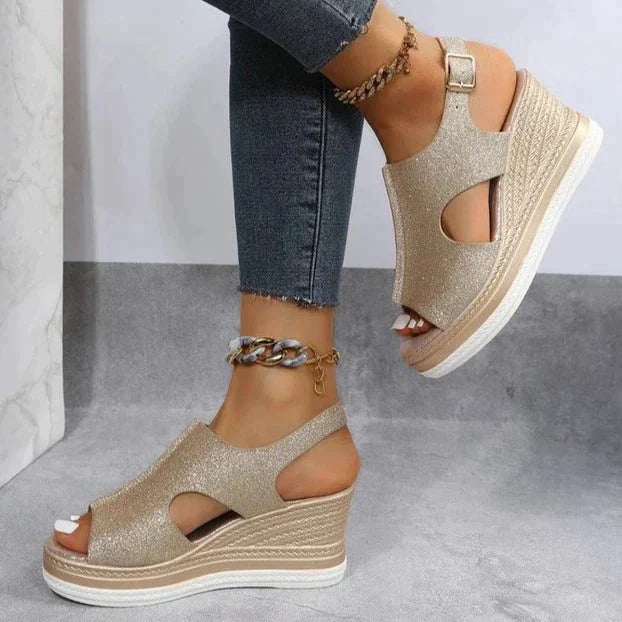 Gold glitter wedge sandals with ankle strap and peep-toe cutouts on braided-texture sole