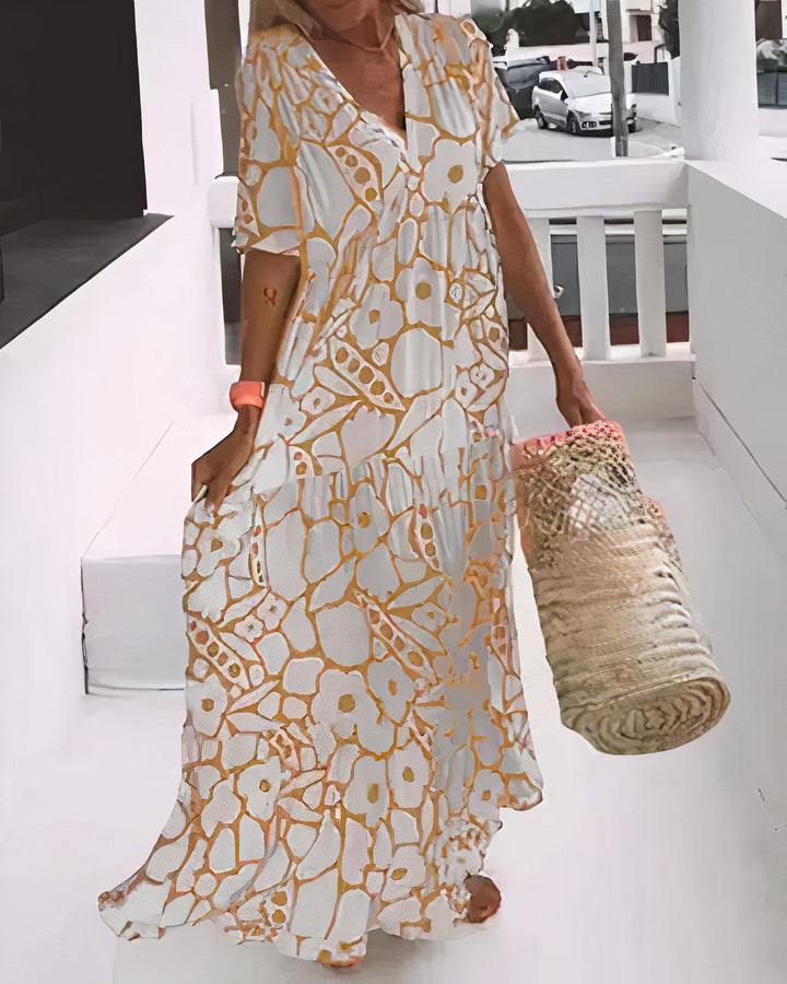Relaxed summer dress in yellow and white abstract print, V-neck, short sleeves, tiered hem