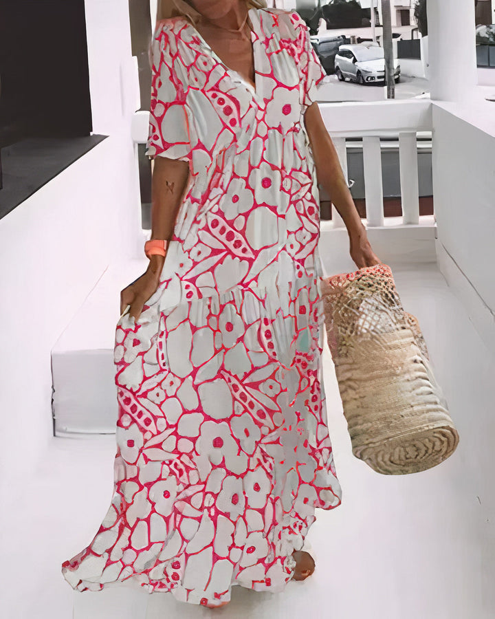 Relaxed summer dress in pink and white abstract print, V-neck, short sleeves, tiered hem