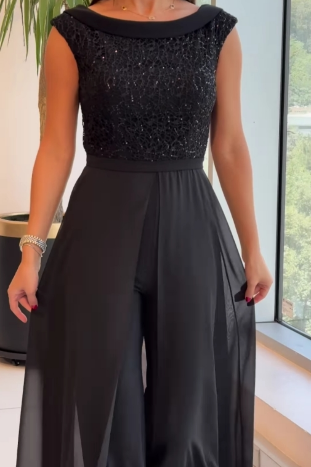 Black sleeveless textured tulle jumpsuit with scoop neckline and draped wide legs