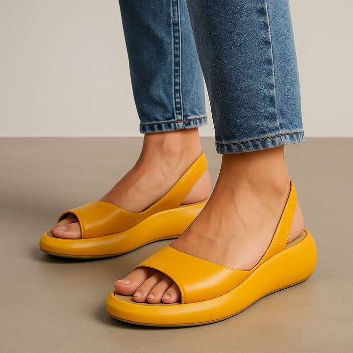 Bright yellow open-toe wedge sandals with wide front strap and cushioned sole