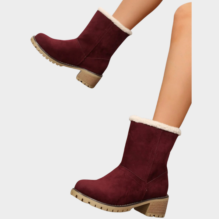 Burgundy winter boots with faux-sherpa trim, stitched vamp, and chunky lug outsole