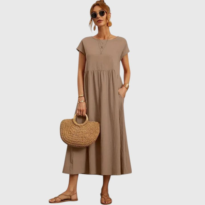 Beige midi dress with short sleeves and gathered waist seam; relaxed fit.