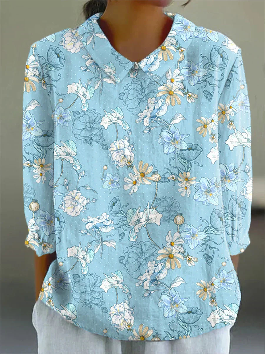 Light blue floral blouse with button-up V-neck, small collar, and 3/4 sleeves