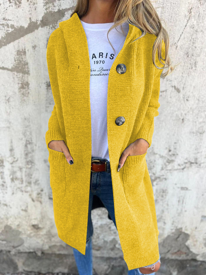 Yellow long knit cardigan with hood and button front, featuring roomy patch pockets.