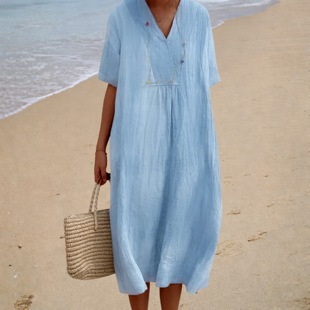 Light blue summer dress with V-neck, short sleeves, button front, and gathered waist
