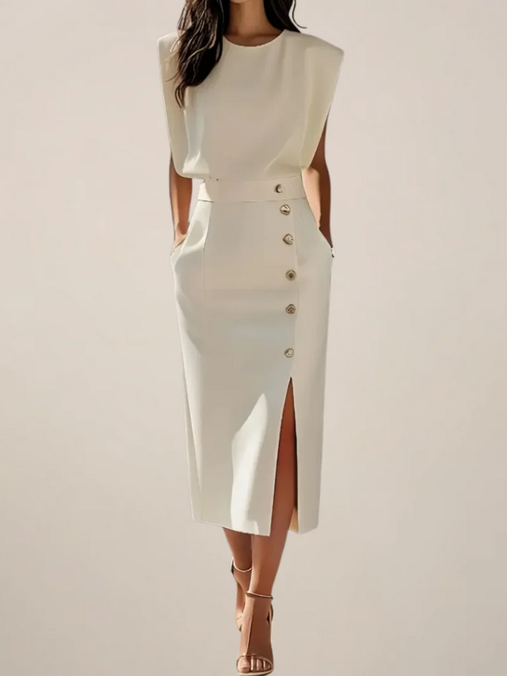 Cream midi dress, sleeveless, with gold button front and side slit.