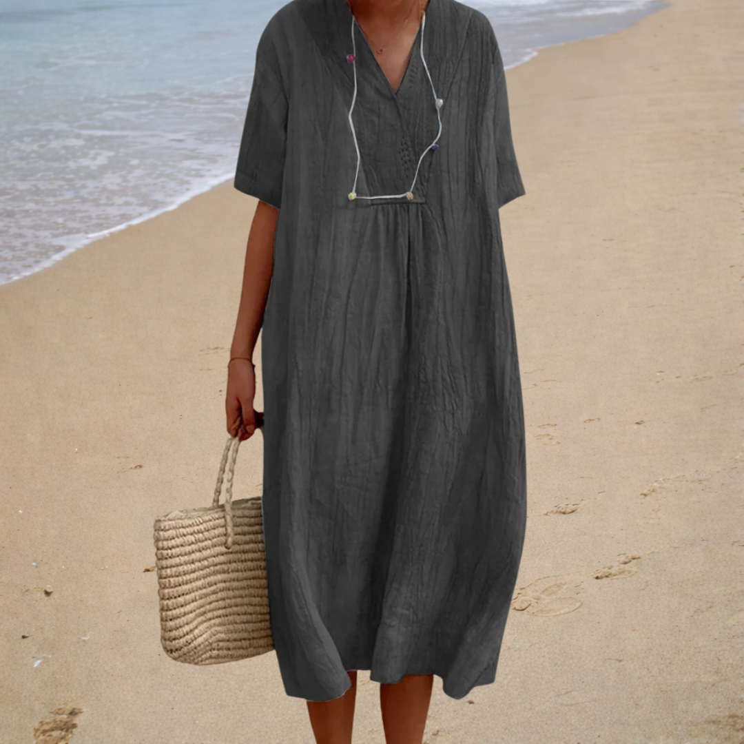 Dark gray summer dress with V-neck, short sleeves, button front, and gathered waist