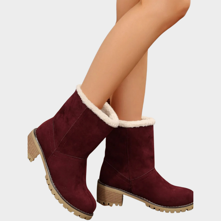 Burgundy suede winter boots with faux-sherpa cuff, side seams, and chunky lug sole