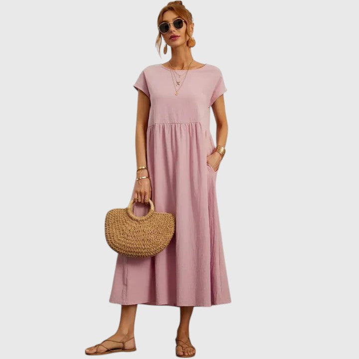 Light pink midi dress with short sleeves and gathered waist seam; relaxed fit.