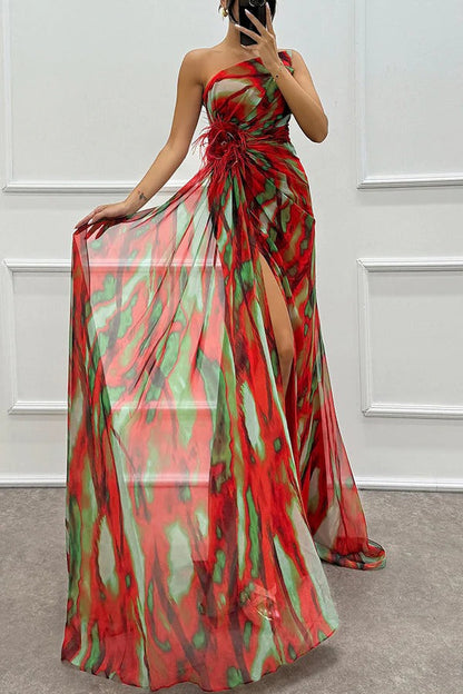 Red strapless maxi dress with abstract print, feathered floral waist detail, and side slit