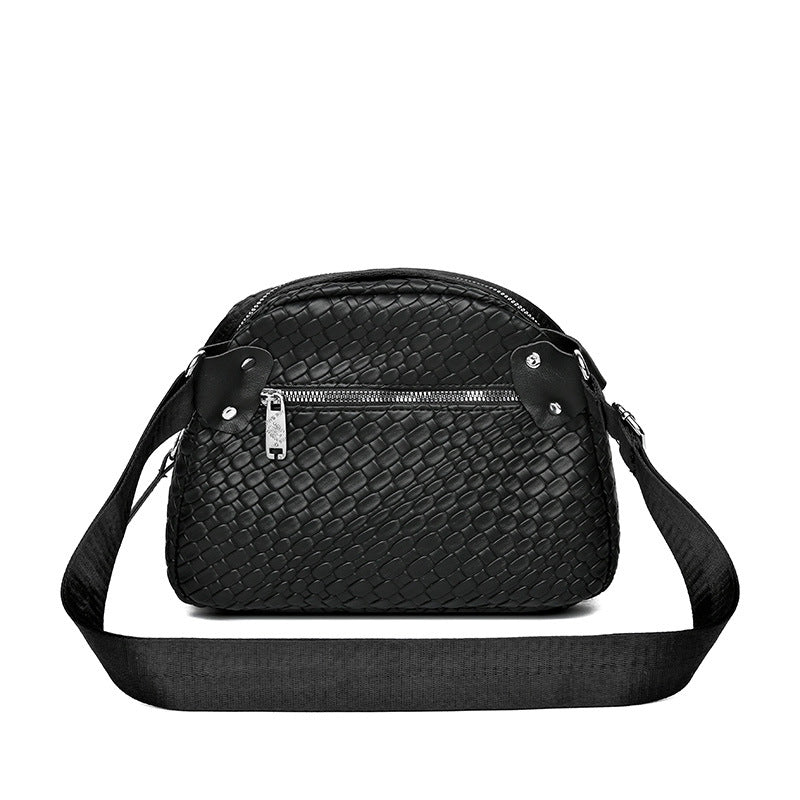 Black woven-texture shell crossbody bag with zip top and wide crossbody strap
