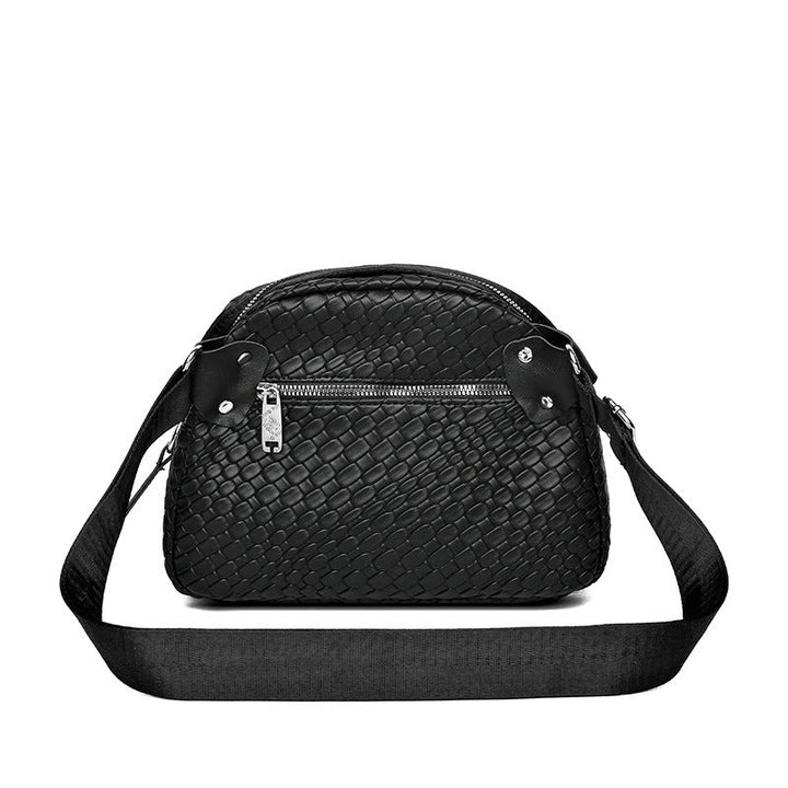 Black woven-texture shell crossbody bag with zip top and wide crossbody strap