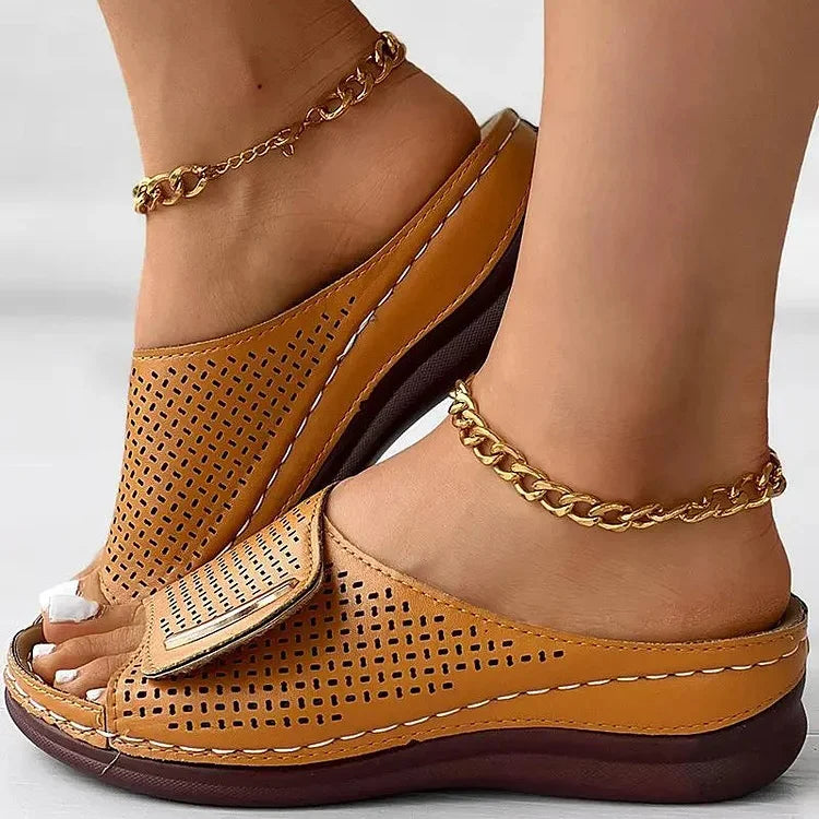 Perforated slide sandals in tan with wide toe strap and cushioned sole