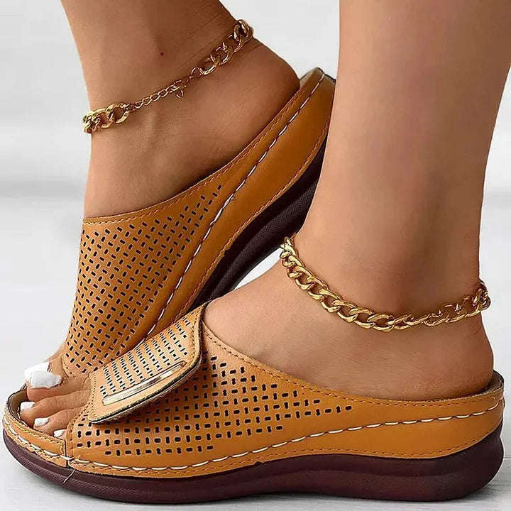 Perforated slide sandals in tan with wide toe strap and cushioned sole
