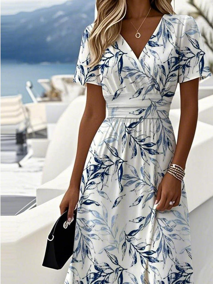 White midi wrap-style dress with blue botanical print, V-neck and short sleeves