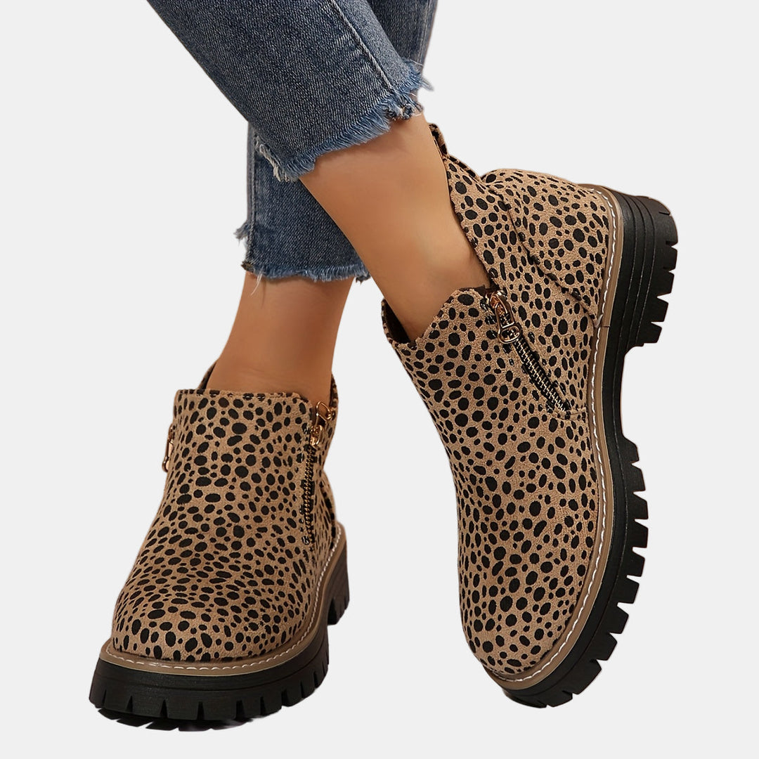 Leopard print ankle boots with side zipper and black lug sole, round toe.