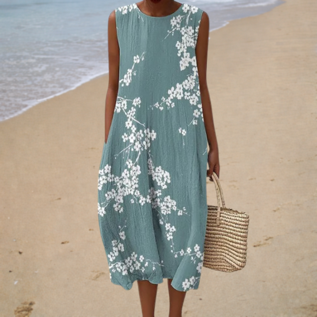 Teal sleeveless summer dress with white floral print, round neckline, midi length