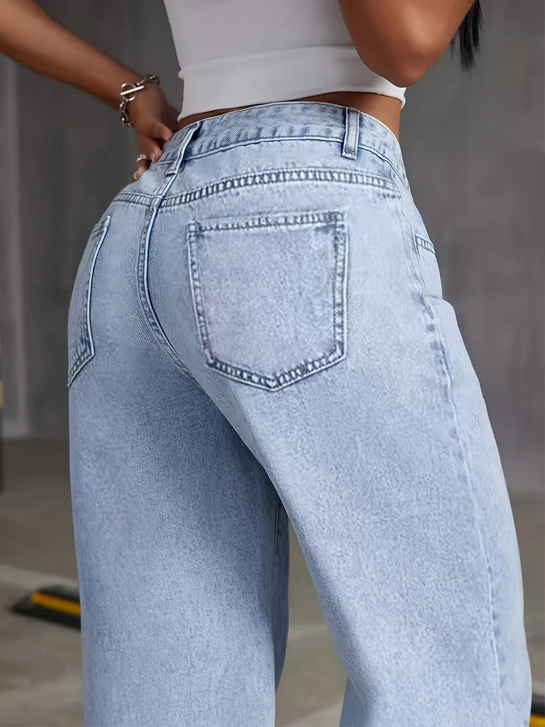 Light blue high-waisted wide-leg denim jeans, close-up back yoke and patch pocket