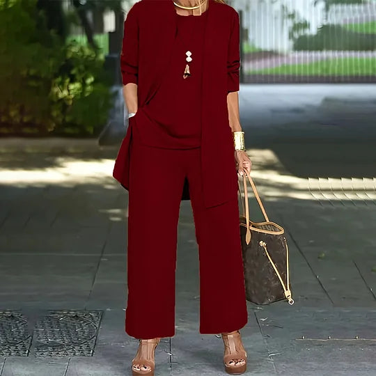 Red three-piece set with open cardigan over short-sleeve top and wide-leg trousers