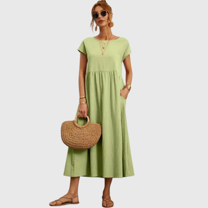 Light green midi dress with short sleeves and gathered waist seam; relaxed fit.