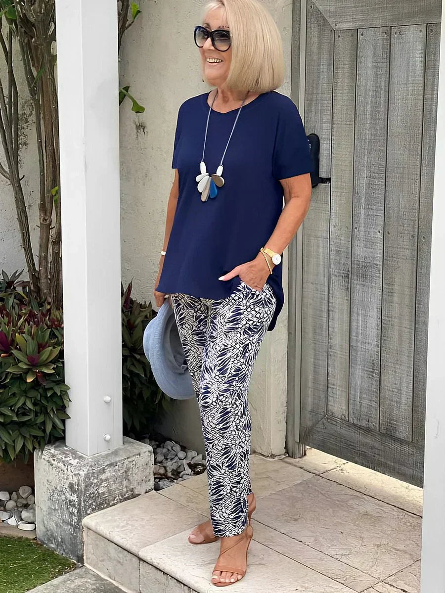 Loose-fit navy top with short sleeves and black-white printed flowy ankle pants