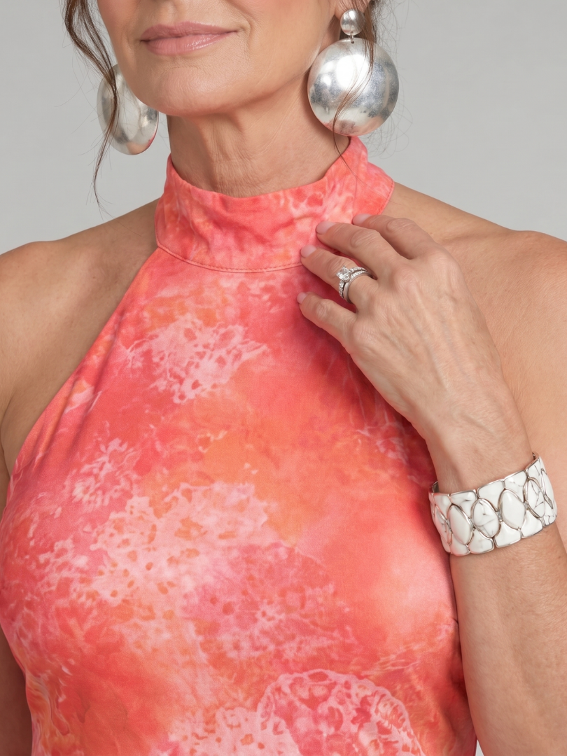 Orange halter maxi dress with high neckline and abstract printed pattern
