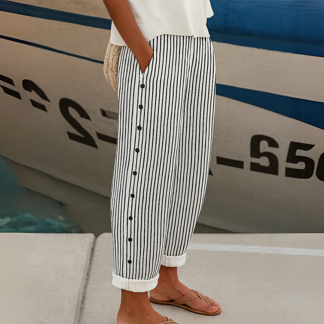 Indira striped casual pants with black vertical lines and button front, cuffed ankle