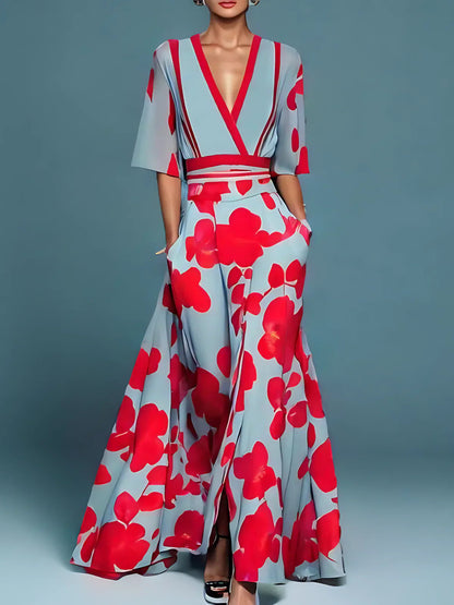 Floral maxi dress in light blue with bold red floral print, V-neck, short sleeves, waist sash