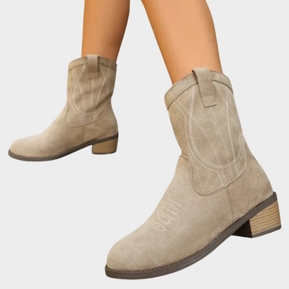Taupe suede cowboy ankle boots, side profile with stitched design and short block heel