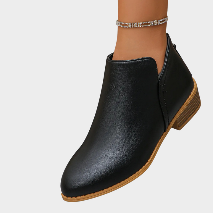 Black low-heel ankle boot with tan stacked heel and side seam stitching