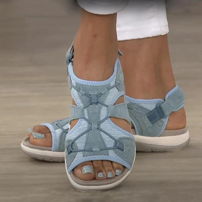 Light blue orthopaedic sandals with cross-laced straps, buckle strap, and thick sole