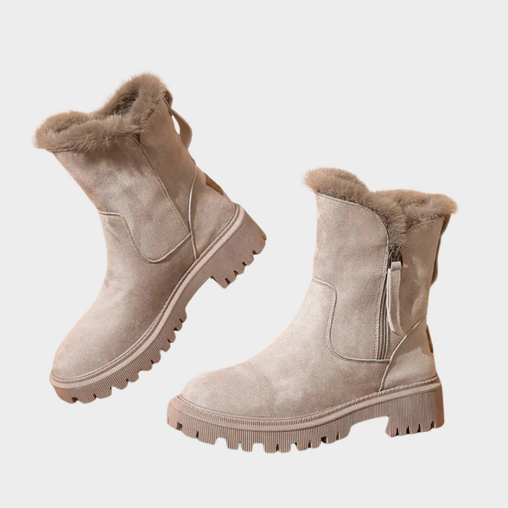 Beige comfort boots with faux-fur collars, side zippers, and chunky tread soles