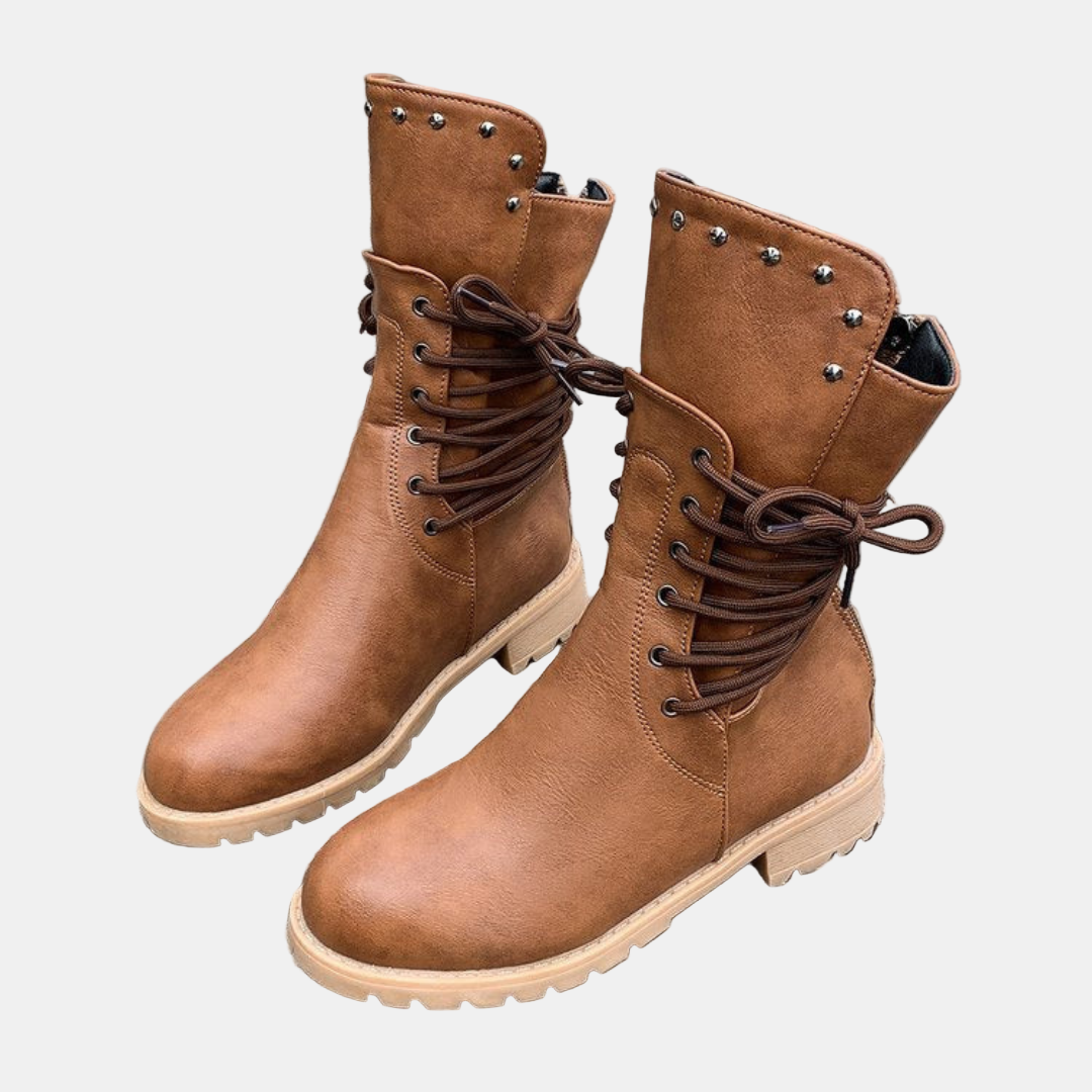 Brown mid-length lace-up walking boots with metal stud details and rugged rubber sole